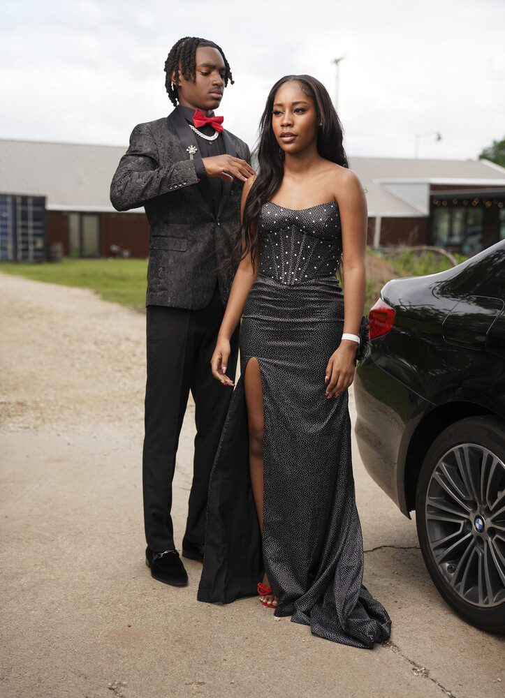 Jalen Jackson with his prom date near the car before prom